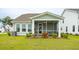 Screened porch with seating area and backyard view at 729 Opal Wing St, Moncks Corner, SC 29461