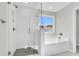 Bathroom with soaking tub and walk-in shower, featuring modern fixtures at 733 Opal Wing St, Moncks Corner, SC 29461