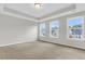 Spacious bedroom with three windows and neutral wall colors at 733 Opal Wing St, Moncks Corner, SC 29461