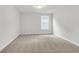 Simple bedroom with neutral carpeting and a window at 733 Opal Wing St, Moncks Corner, SC 29461