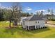 Gray two-story home with a screened porch and grassy backyard at 735 Opal Wing St, Moncks Corner, SC 29461