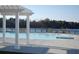 Relaxing community pool area with pergola and lake view at 735 Opal Wing St, Moncks Corner, SC 29461
