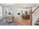 Open concept dining room with hardwood floors and view to kitchen at 735 Opal Wing St, Moncks Corner, SC 29461