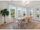 Light-filled dining area with hardwood floors and a farmhouse table at 735 Opal Wing St, Moncks Corner, SC 29461