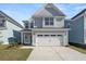 Two-story house with gray siding, white trim, and a two-car garage at 735 Opal Wing St, Moncks Corner, SC 29461