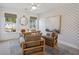 Bright home office features wood accents, a large art piece, and comfortable seating at 735 Opal Wing St, Moncks Corner, SC 29461