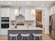Modern kitchen with white cabinets, quartz countertops, and a large island at 735 Opal Wing St, Moncks Corner, SC 29461