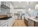 Modern kitchen with white cabinets, stainless steel appliances, and farmhouse sink at 735 Opal Wing St, Moncks Corner, SC 29461