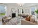 Bright living room features a fireplace, large windows, and comfortable seating at 735 Opal Wing St, Moncks Corner, SC 29461