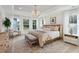 Spacious main bedroom with a large bed, sitting area, and plenty of natural light at 735 Opal Wing St, Moncks Corner, SC 29461