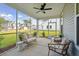 Relaxing screened porch with wicker furniture and ceiling fan at 735 Opal Wing St, Moncks Corner, SC 29461