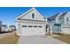 Two-story house with gray siding, white garage door, and landscaping at 767 Opal Wing St, Moncks Corner, SC 29461