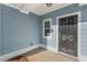 Dark brown front door with sidelight window at 767 Opal Wing St, Moncks Corner, SC 29461
