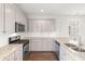 Modern kitchen with granite countertops and stainless steel appliances at 767 Opal Wing St, Moncks Corner, SC 29461