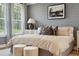 Main bedroom with gray shiplap accent wall and ample natural light at 775 Opal Wing St, Moncks Corner, SC 29461