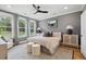 Spacious bedroom with gray shiplap wall, hardwood floors, and large windows at 775 Opal Wing St, Moncks Corner, SC 29461