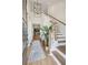 Bright entryway with hardwood floors, staircase, and view to kitchen at 775 Opal Wing St, Moncks Corner, SC 29461