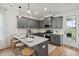 Open concept kitchen boasts a large island with seating and marble countertop at 775 Opal Wing St, Moncks Corner, SC 29461