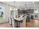Bright kitchen features gray cabinets, an island, and hardwood floors at 775 Opal Wing St, Moncks Corner, SC 29461