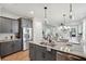 Spacious kitchen with island, stainless steel appliances, and hardwood floors at 775 Opal Wing St, Moncks Corner, SC 29461