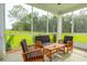 Relaxing screened porch with wooden furniture and view at 775 Opal Wing St, Moncks Corner, SC 29461