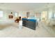 Open concept kitchen and living area with a large island and fireplace at 815 Dunham St, Charleston, SC 29492