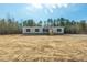 New manufactured home with gray siding, a wooden deck, and ample land at 857 Devines Way, Cross, SC 29436