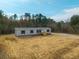Newly constructed single-Gathering home with gray vinyl siding, and a wooden deck at 857 Devines Way, Cross, SC 29436