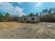 Newly built manufactured home on a large lot, surrounded by trees at 857 Devines Way, Cross, SC 29436