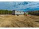 Rear view of a manufactured home showcasing a deck and spacious yard at 857 Devines Way, Cross, SC 29436