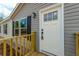 Close-up of a white front door with six pane windows and black hardware at 857 Devines Way, Cross, SC 29436
