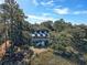 Aerial view of a charming two-story home nestled in lush greenery at 8934 Sandy Creek Rd, Edisto Island, SC 29438