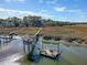 Aerial view of waterfront home with private dock and expansive marsh views at 8934 Sandy Creek Rd, Edisto Island, SC 29438