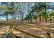 Fenced backyard with mature trees and landscaping at 8934 Sandy Creek Rd, Edisto Island, SC 29438