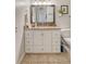 Clean bathroom with granite countertop, white cabinets, and tile flooring at 8934 Sandy Creek Rd, Edisto Island, SC 29438