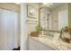 Bathroom features granite countertop, a shower, and a charming mirror at 8934 Sandy Creek Rd, Edisto Island, SC 29438