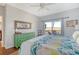 Bedroom with king bed, green dresser, and access to private deck at 8934 Sandy Creek Rd, Edisto Island, SC 29438