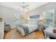 Bright bedroom with a queen-size bed, hardwood floors, and ample natural light at 8934 Sandy Creek Rd, Edisto Island, SC 29438
