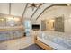 Main bedroom with TV, sitting area, and sliding barn doors at 8934 Sandy Creek Rd, Edisto Island, SC 29438