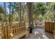 Wooden deck with bench and view of wooded area at 8934 Sandy Creek Rd, Edisto Island, SC 29438