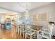 Bright dining room featuring a large wooden table and chandelier, adjacent to kitchen at 8934 Sandy Creek Rd, Edisto Island, SC 29438