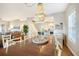 Bright dining room featuring a wooden table and unique chandelier at 8934 Sandy Creek Rd, Edisto Island, SC 29438