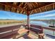 Covered wooden dock with benches, overlooking a peaceful waterway at 8934 Sandy Creek Rd, Edisto Island, SC 29438