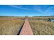 Long wooden dock leading to a gazebo over the water at 8934 Sandy Creek Rd, Edisto Island, SC 29438