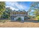 Two story home with wrap around porch, detached shed, and expansive yard at 8934 Sandy Creek Rd, Edisto Island, SC 29438