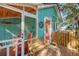 Screened porch with wooden bench and red rocking chairs at 8934 Sandy Creek Rd, Edisto Island, SC 29438