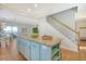 Open concept kitchen with a teal island and granite countertops at 8934 Sandy Creek Rd, Edisto Island, SC 29438
