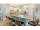 Spacious kitchen with white cabinets, granite countertops and teal island at 8934 Sandy Creek Rd, Edisto Island, SC 29438