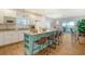 Bright kitchen with white cabinets, granite countertops, and a teal island at 8934 Sandy Creek Rd, Edisto Island, SC 29438