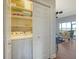 Convenient laundry room with washer, dryer, and storage shelves at 8934 Sandy Creek Rd, Edisto Island, SC 29438